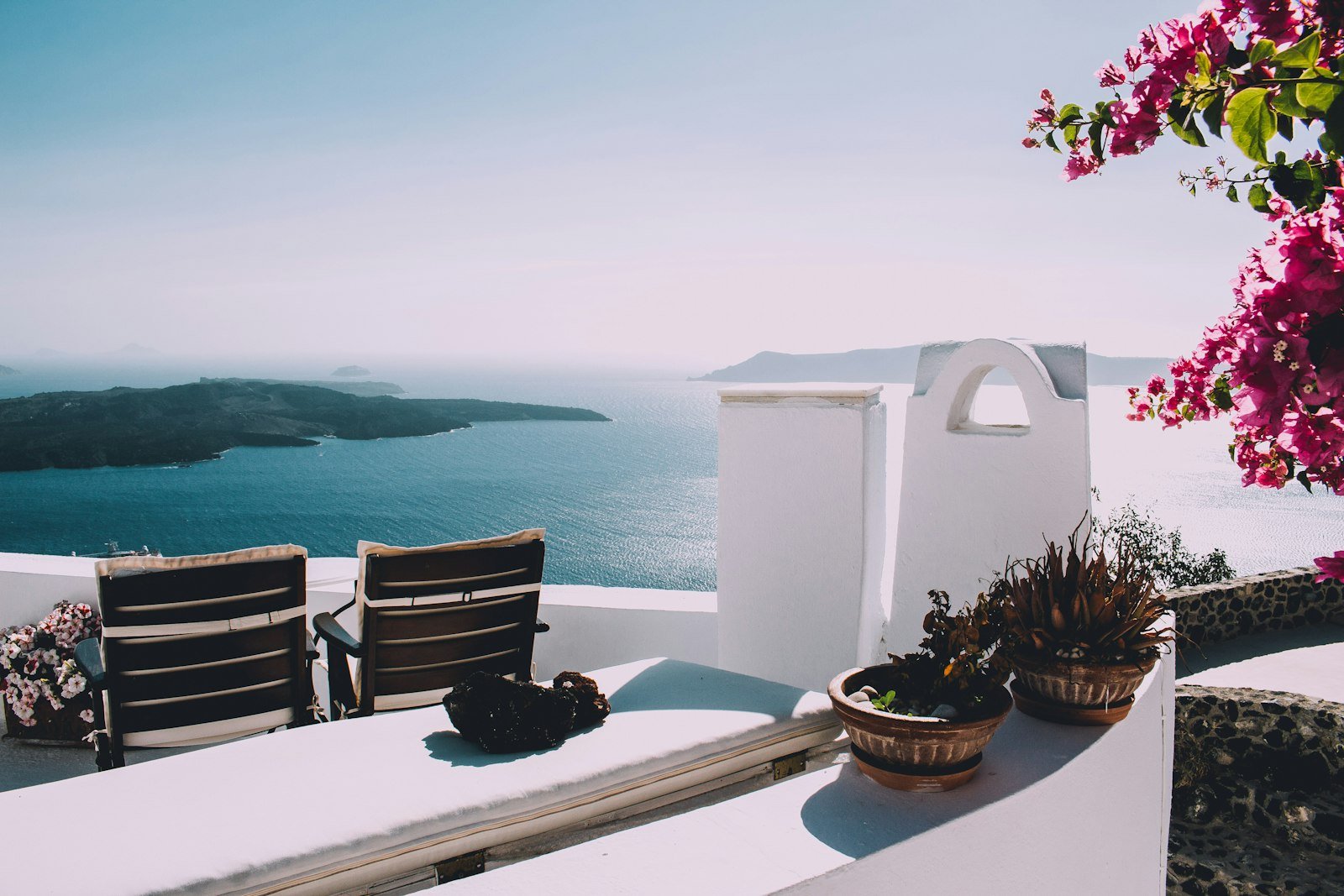 Couple on a terrace overlooking the sea at dusk